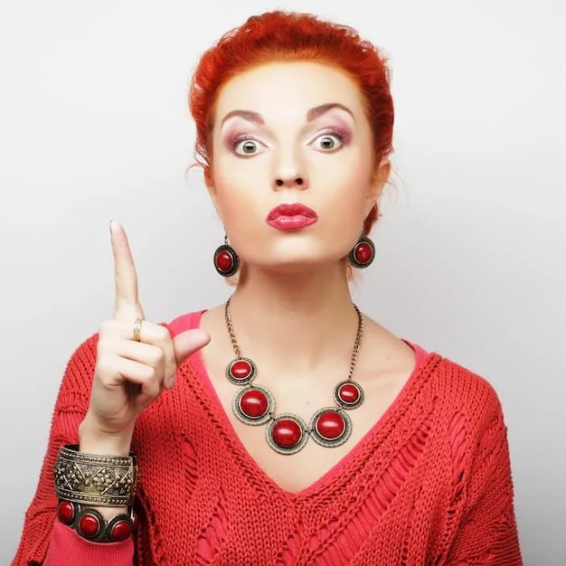 A photo of a modern celebrity wearing a custom-designed piece of jewelry on the red carpet. The jewelry is unique and reflects the celebrity's personal style, with elements that tie into their public persona and values. The image captures the close-up details of the piece, highlighting its craftsmanship and design.