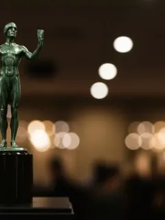 Golden SAG Awards statuette on a pedestal, representing excellence in ensemble acting recognition.