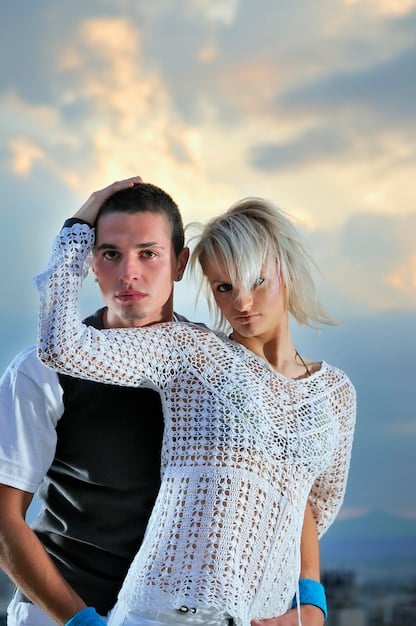 A split-screen image. On one side, a celebrity couple poses for a candid-style photo on Instagram, showcasing a product subtly placed in the background. On the other side, a celebrity couple creates a short, engaging dance video on TikTok, promoting a trending challenge.