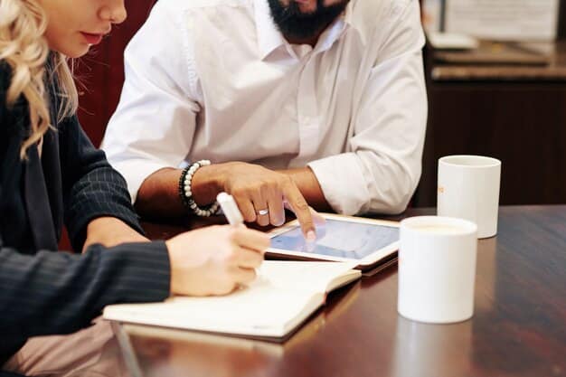 An image showing two sets of hands signing a legal document at a table with financial charts in the background, representing the financial agreement being made with expert advice.