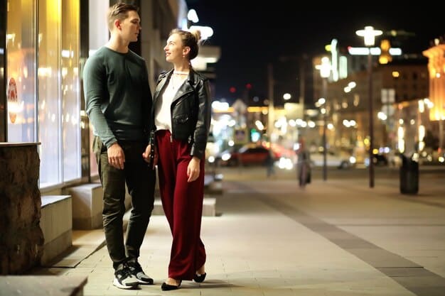 A candid shot of a celebrity couple holding hands while walking down a busy street. They are surrounded by paparazzi, but their focus is on each other, showcasing their ability to maintain a connection despite the intense public attention.