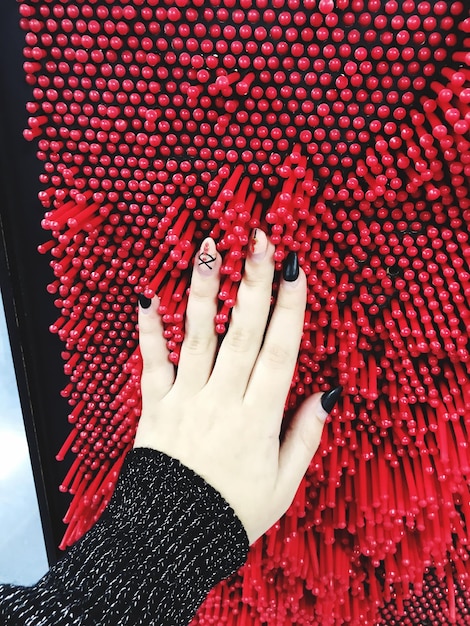 A close-up shot of a biometric scanner being used at a red carpet event, showing the scanner verifying an attendee's fingerprint or facial features. Focus on the seamless integration of the technology with the event's aesthetics.