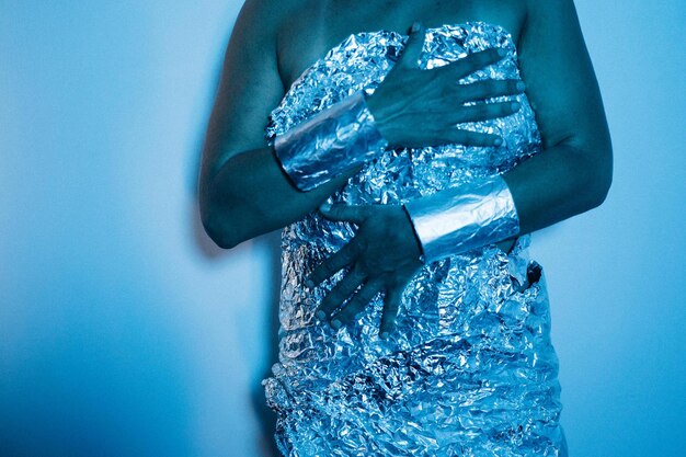 A close-up shot of a celebrity wearing a gown made from recycled ocean plastic, intricately woven with LED lights. The dress shimmers with a subtle, ethereal glow, highlighting the beauty of sustainable fashion.