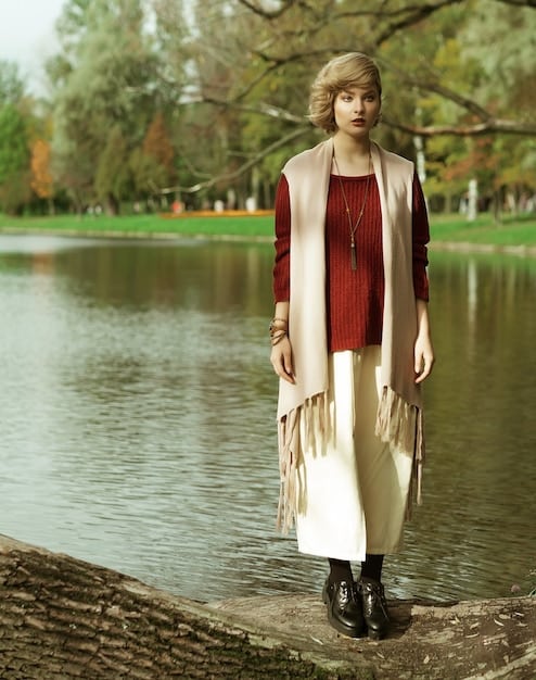 Mockups of red carpet gowns in shades of terracotta, olive green, and sandy beige, demonstrating how earthy neutrals can be both elegant and modern. The backdrop showcases natural textures, such as wood and stone, to emphasize the connection to nature.