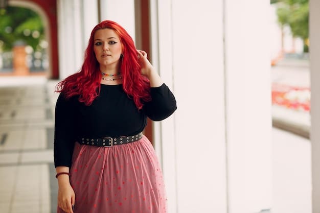 A designer is adjusting the dress on a plus-size model before she goes on the red carpet. The designer is smiling and the model looks happy and confident.