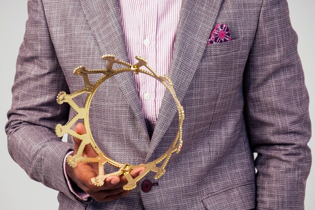 A close-up shot of a celebrity wearing a custom-designed suit with intricate embroidery and embellishments. The focus is on the details of the craftsmanship, capturing the texture of the fabric and the precision of the stitching.