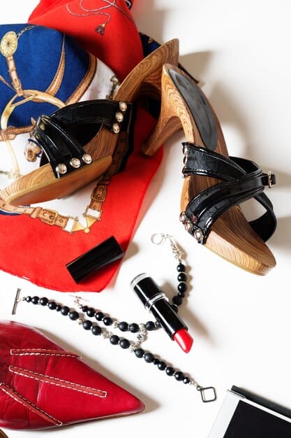 A close-up shot showcasing a variety of affordable accessories, including costume jewelry, metallic heels, and a clutch, arranged to look like a red carpet display. This illustrates how to accessorize on a budget.