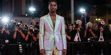 Avant-garde gender-fluid suit with digital elements on red carpet, 2026